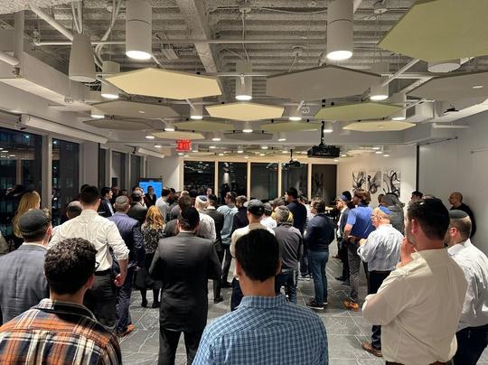 Hundreds of founders and investors standing together at a VIP tech evening